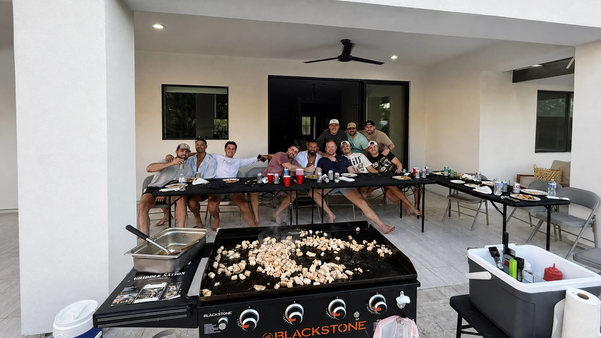 Outdoor hibachi catering station set in front of a seated private group