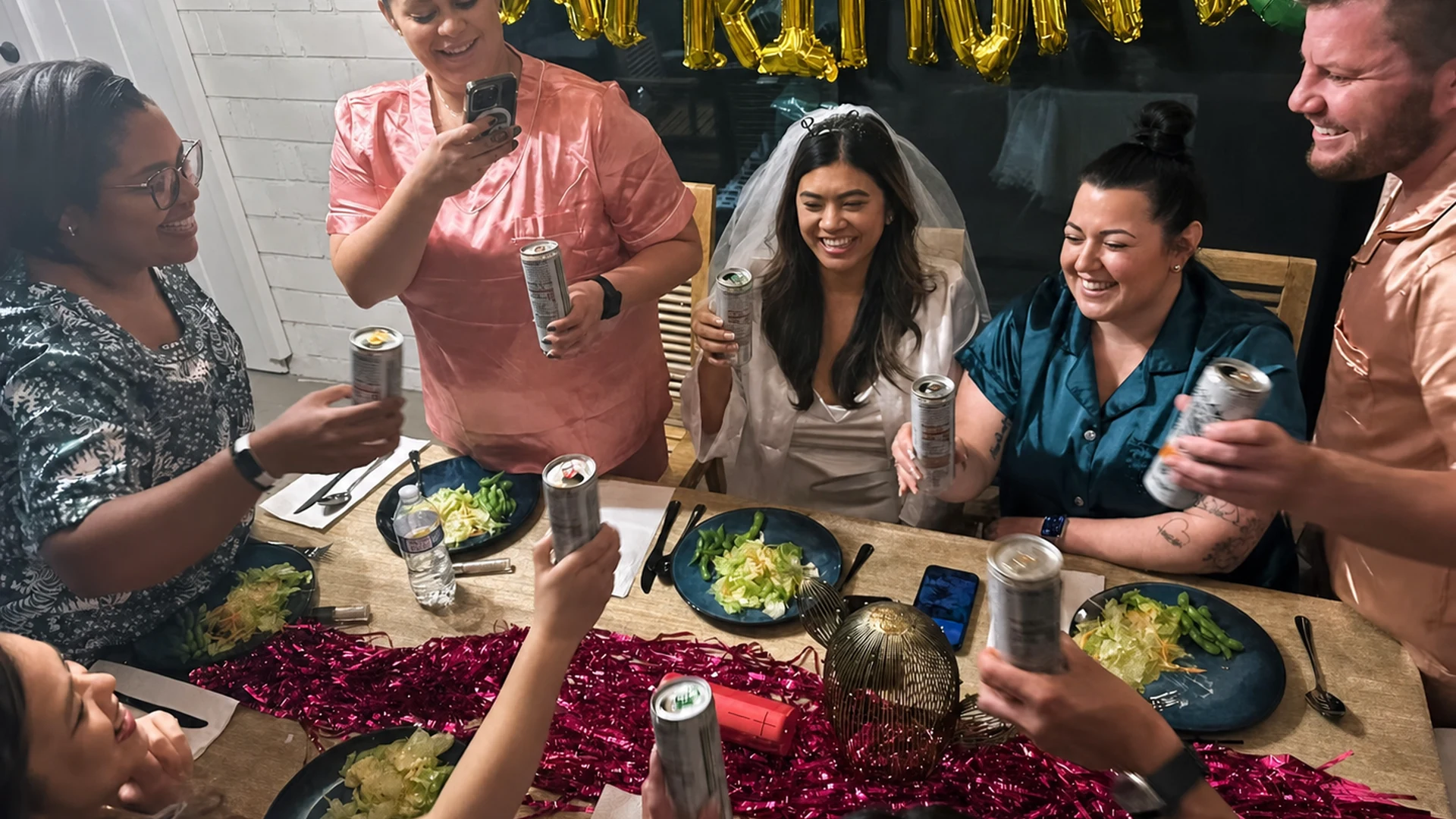 Bachelorette group raising drinks around a private hibachi dinner