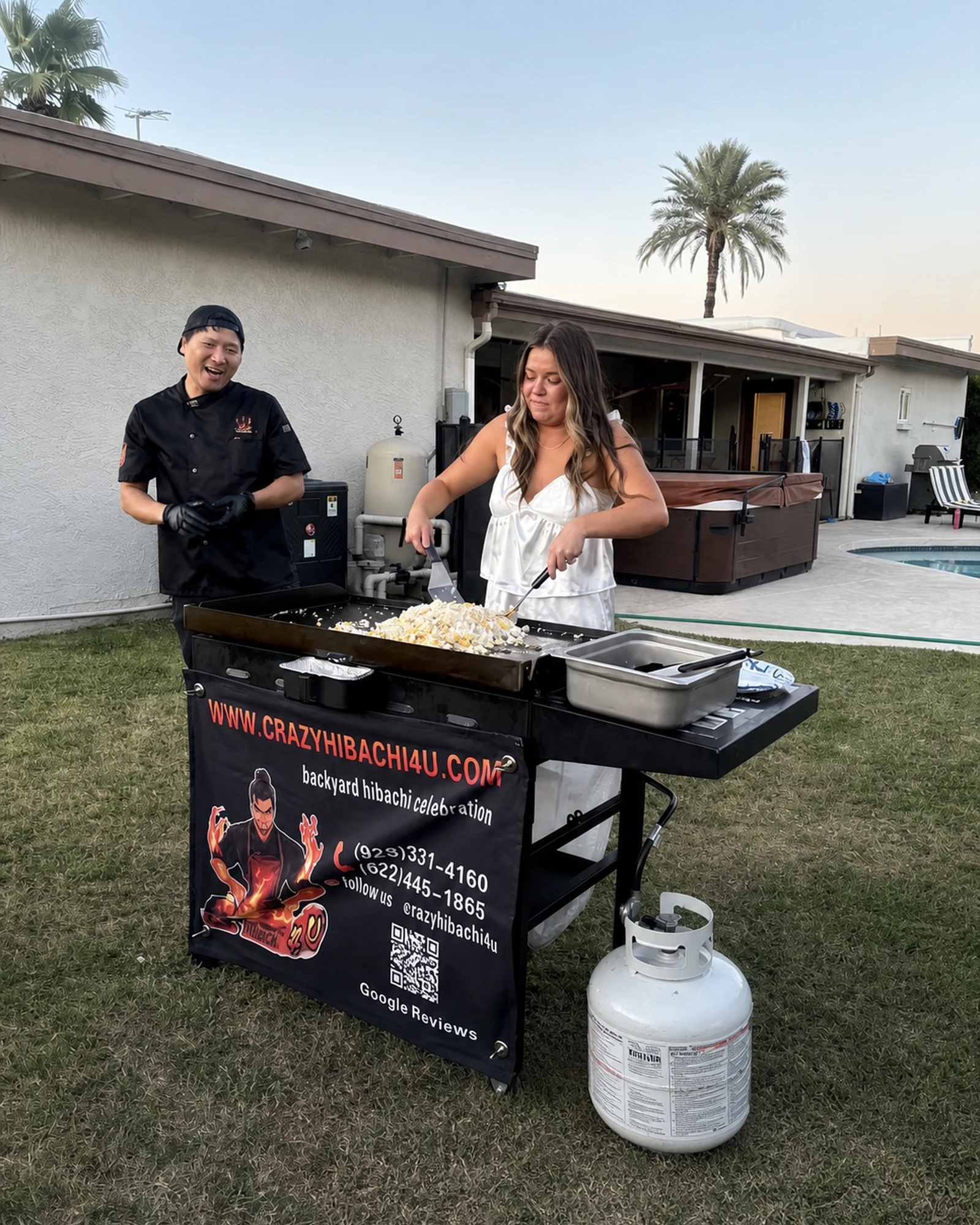 Guest participating with a hibachi chef at a Gilbert catering event