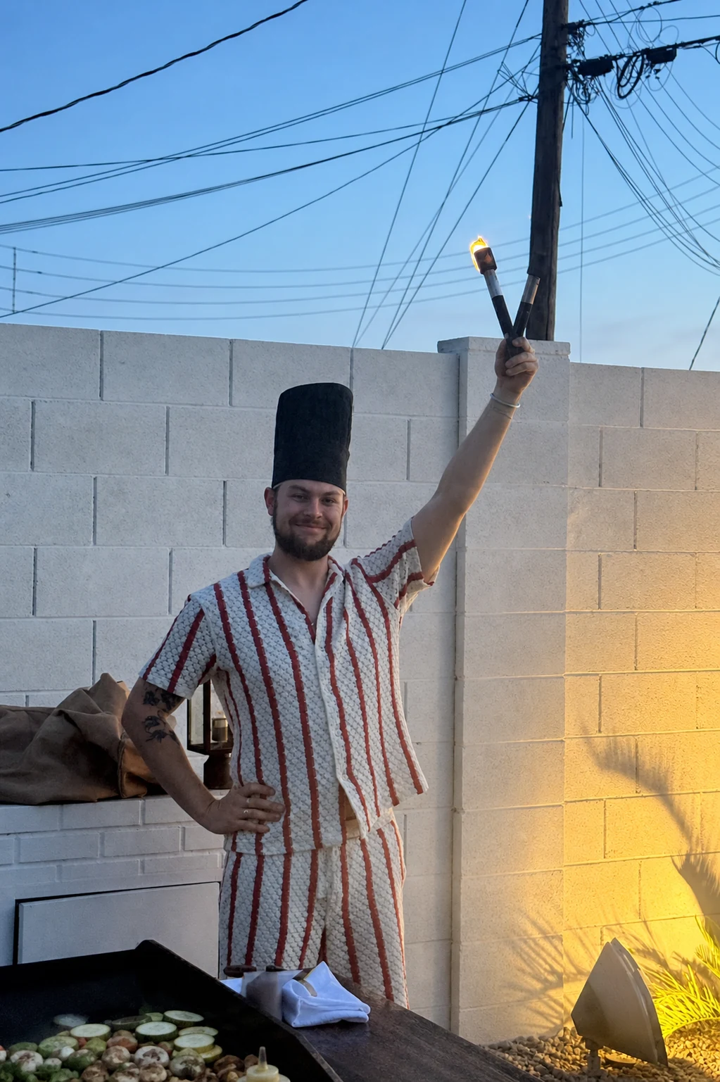 Hibachi chef creating a flame show with a torch