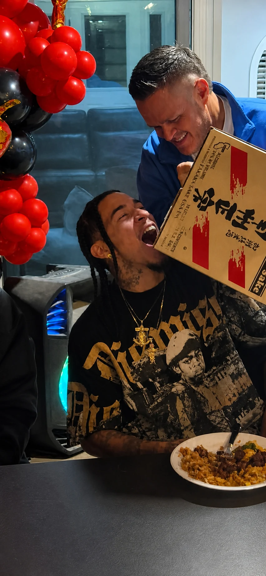 Guest laughing with a pizza during a private party
