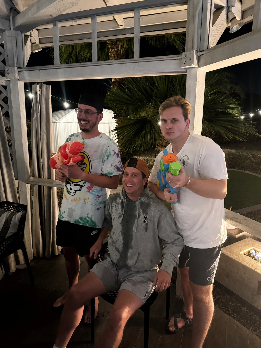 Men joining the water gun game during a hibachi party