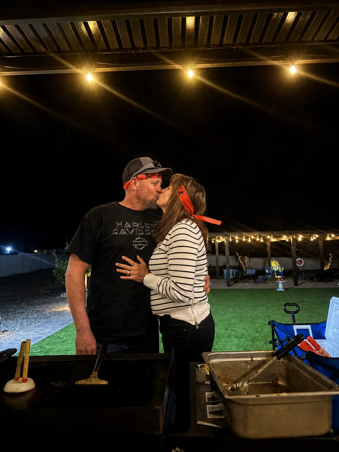 Couple sharing a kiss during a private hibachi celebration