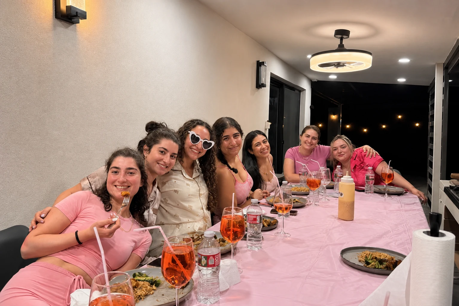 Guests gathered around a pink table for a private hibachi dinner