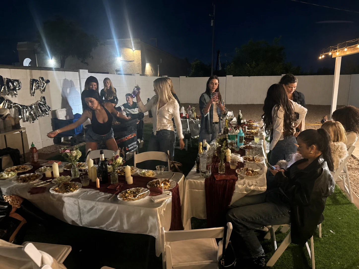 Chef and guests at the end of a nighttime hibachi dinner