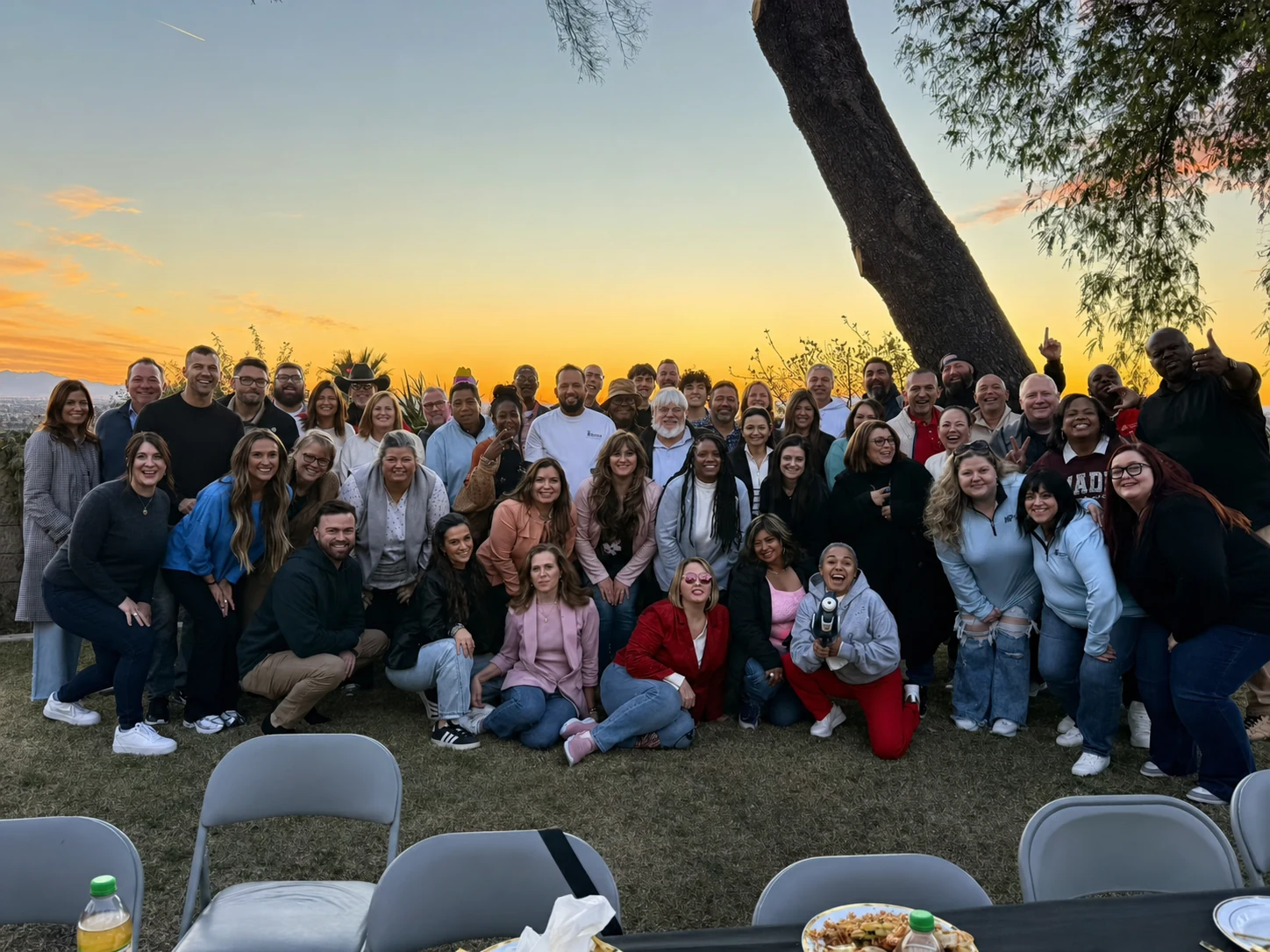 Large group gathered at sunset after a private hibachi dinner